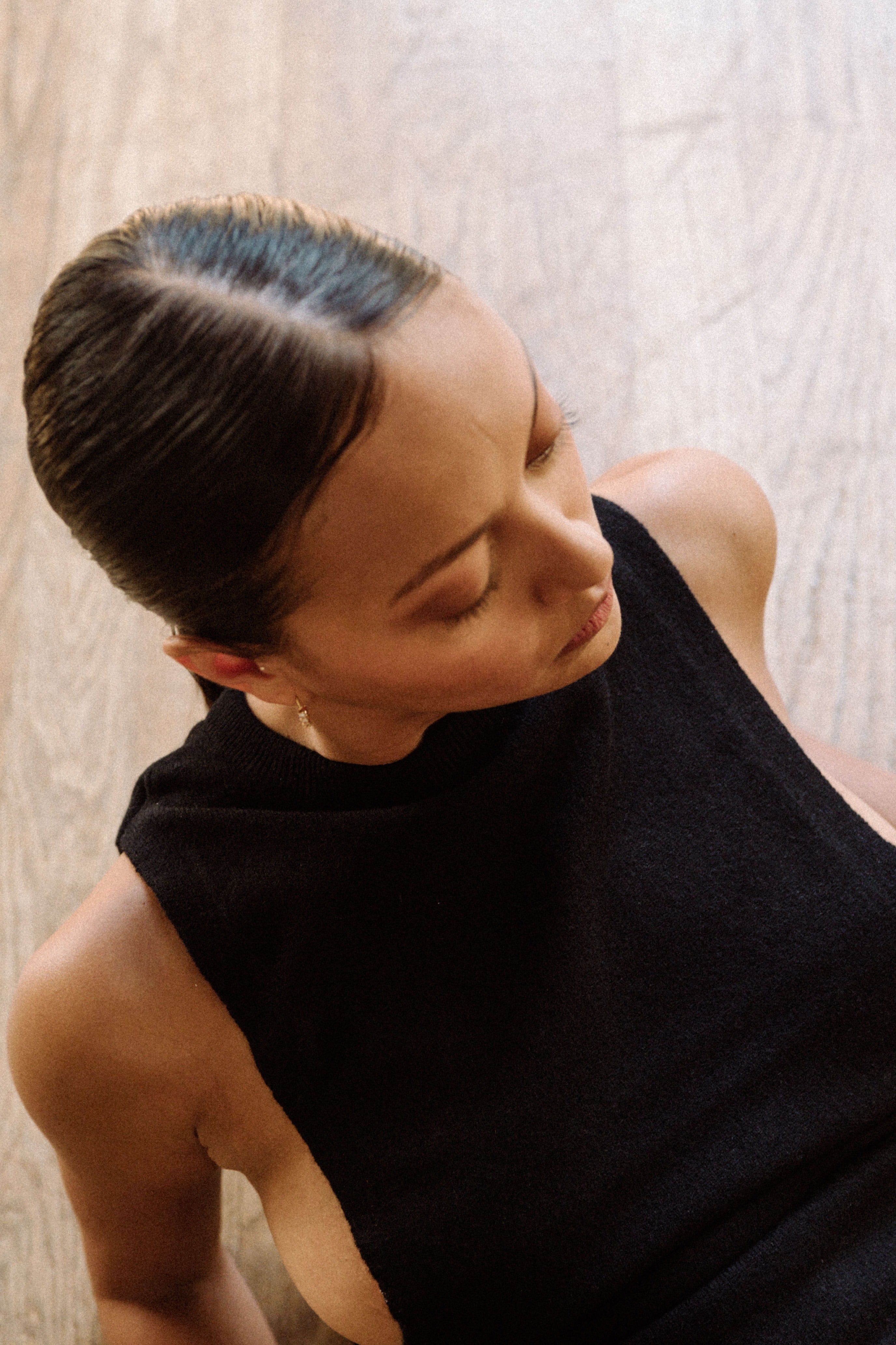 Woman with a ponytail hairstyle wearing black top in a dance studio